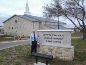 Mike standing by the Spirit of Fort Hood Chapel sign